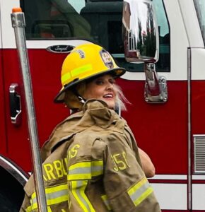 Photo of Hilary in fire fighting uniform